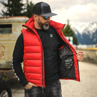 Man in Red Puffer vest showing inside pockets